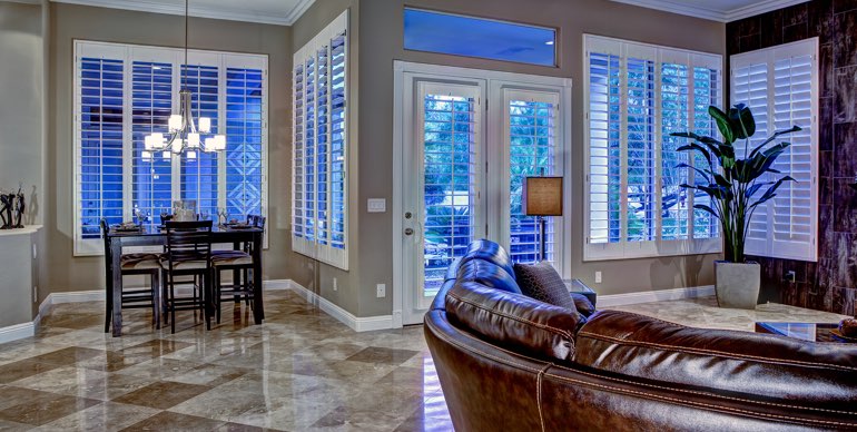 Austin great room with classic shutters and tile floor.